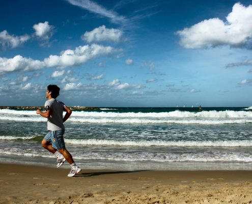 sportsman running on the beach